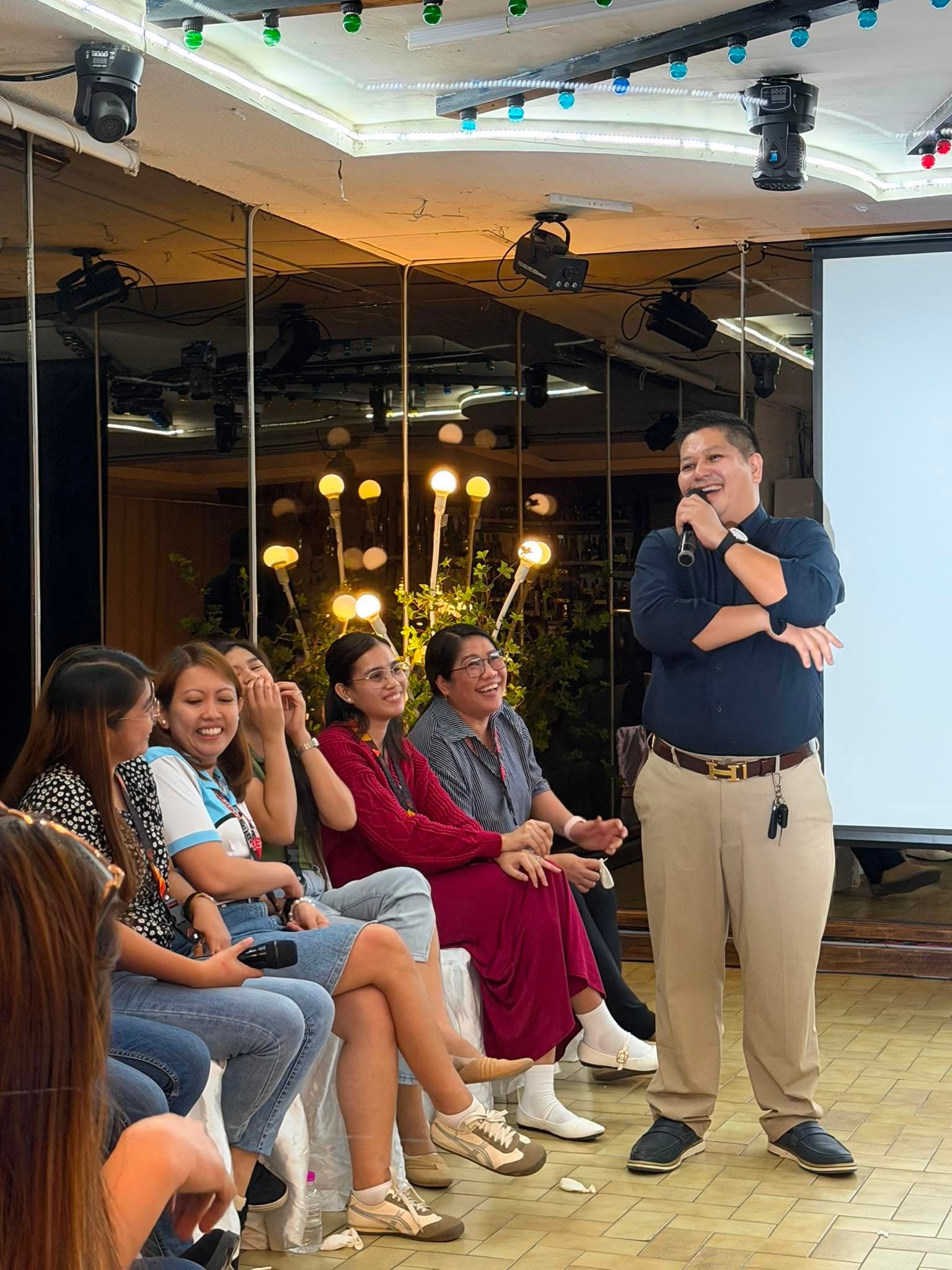 Jennyson engaging an audience during an interactive learning session